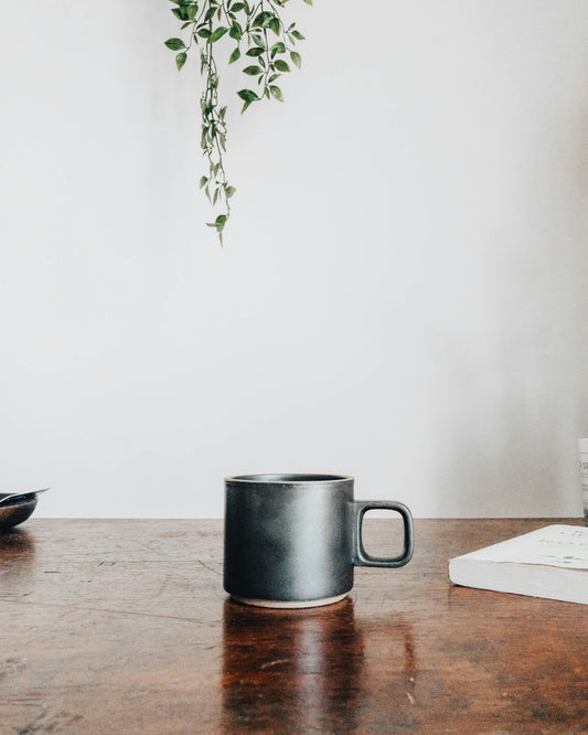 black ceramic mug on brown wooden table