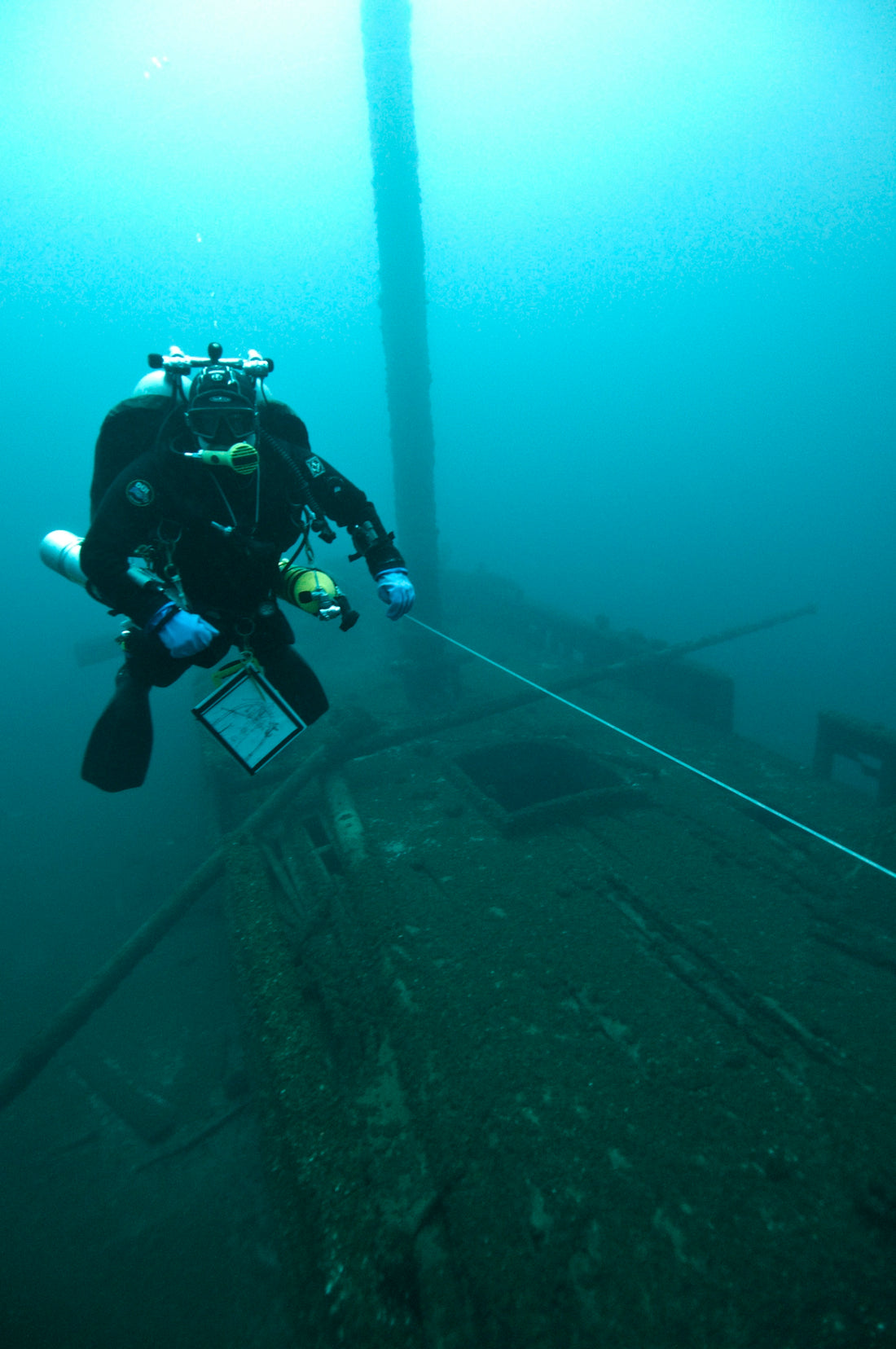 person wearing black flippers in body of water
