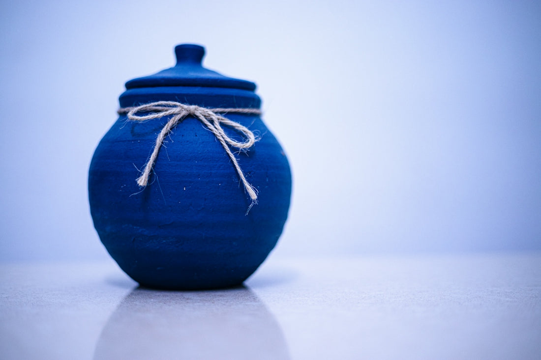 A blue jar decorated with a simple bow