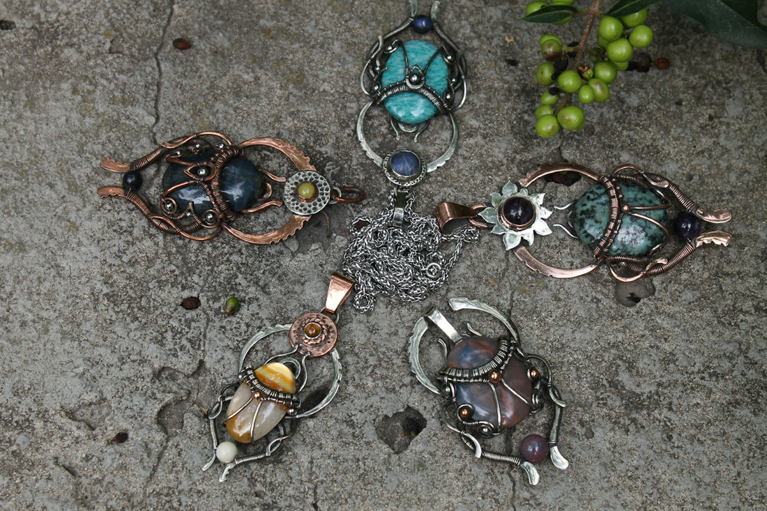 Five unique handcrafted pendants arranged in a star pattern